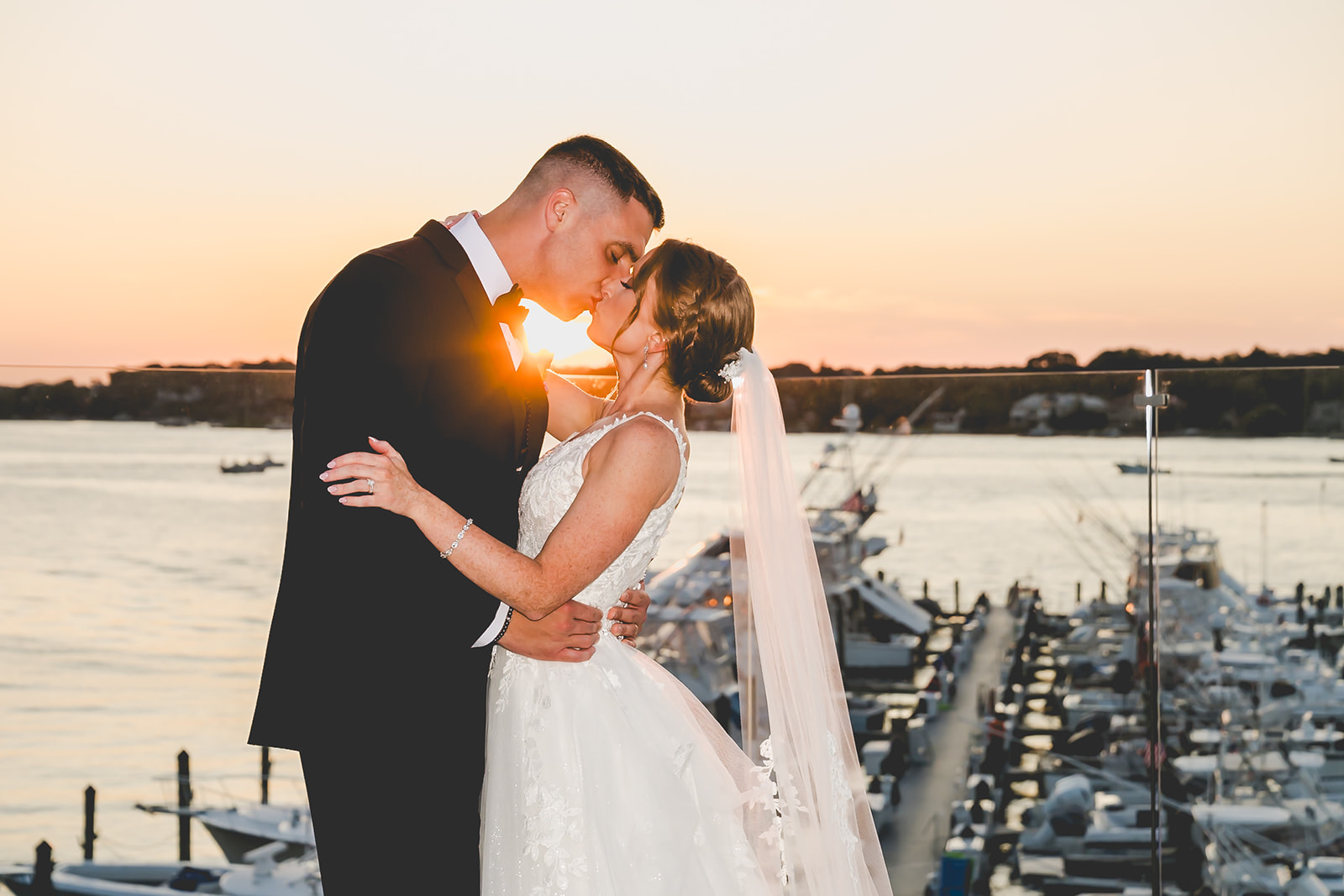 Bride and groom at sunset overlooking yacht club